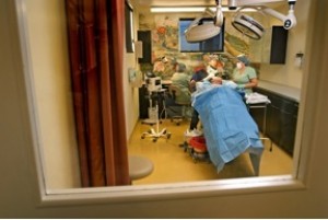 DHC staff prepping a patient in the operating room. 